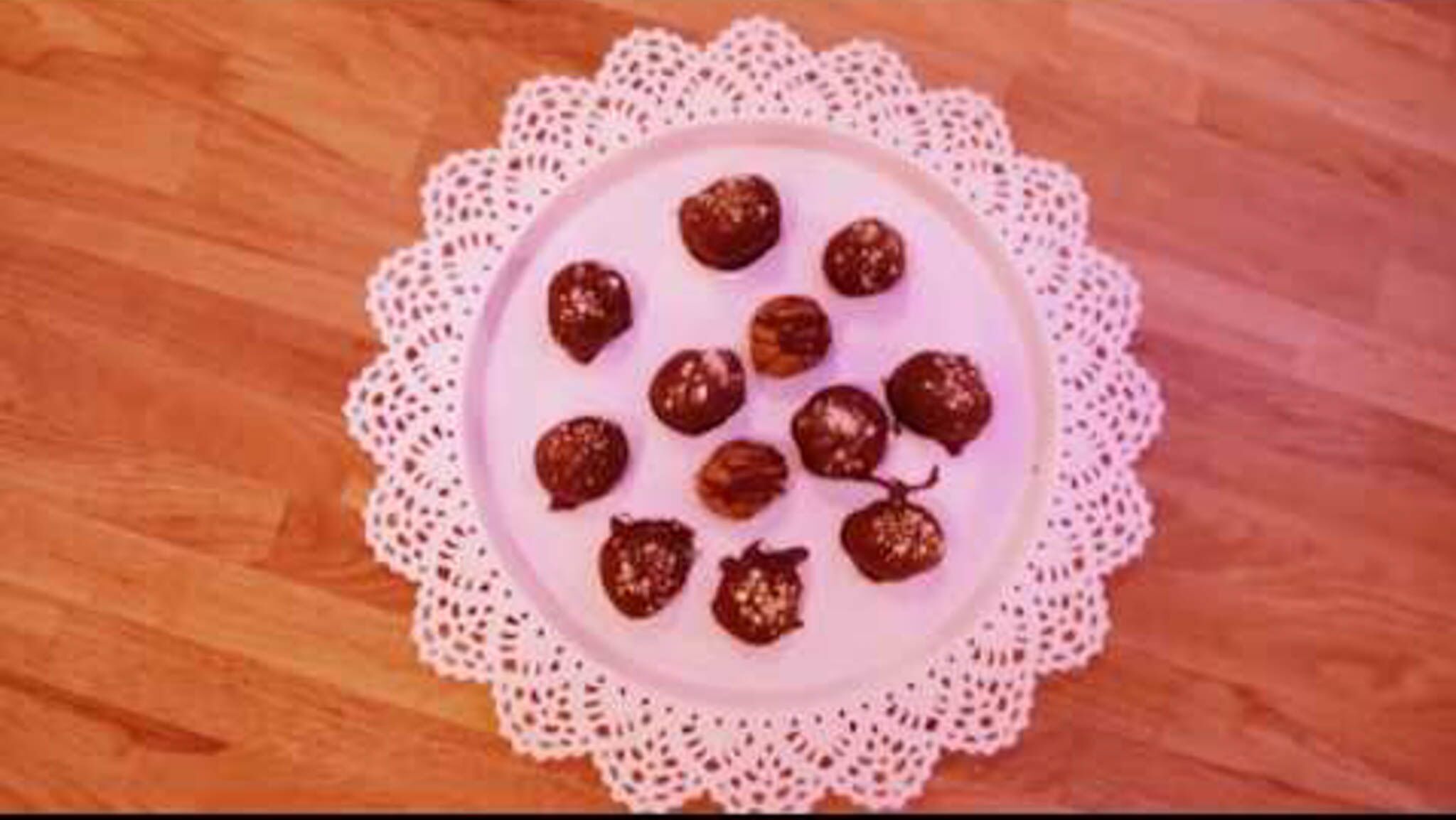 The Real Food Academy power energy balls on a pink plate.