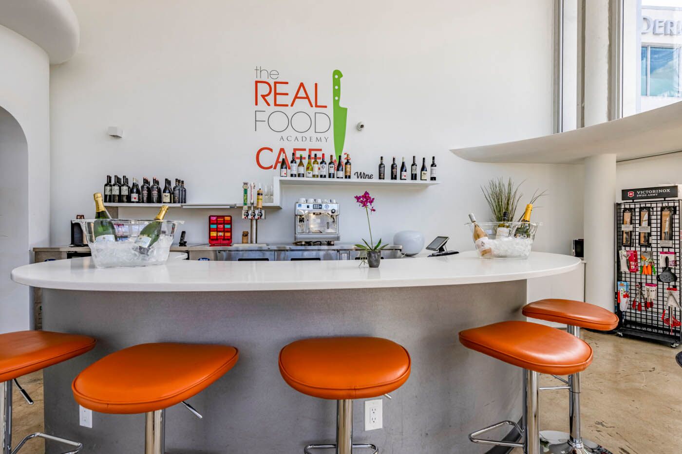 The Real Food Academy bar with orange chairs.