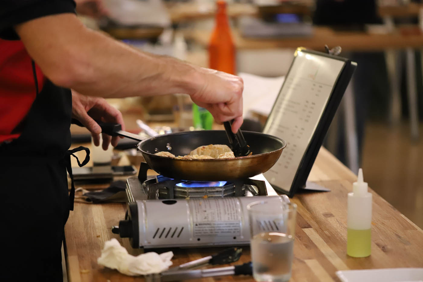 A corporate team cooking fresh pot stickers at our corporate party venue.
