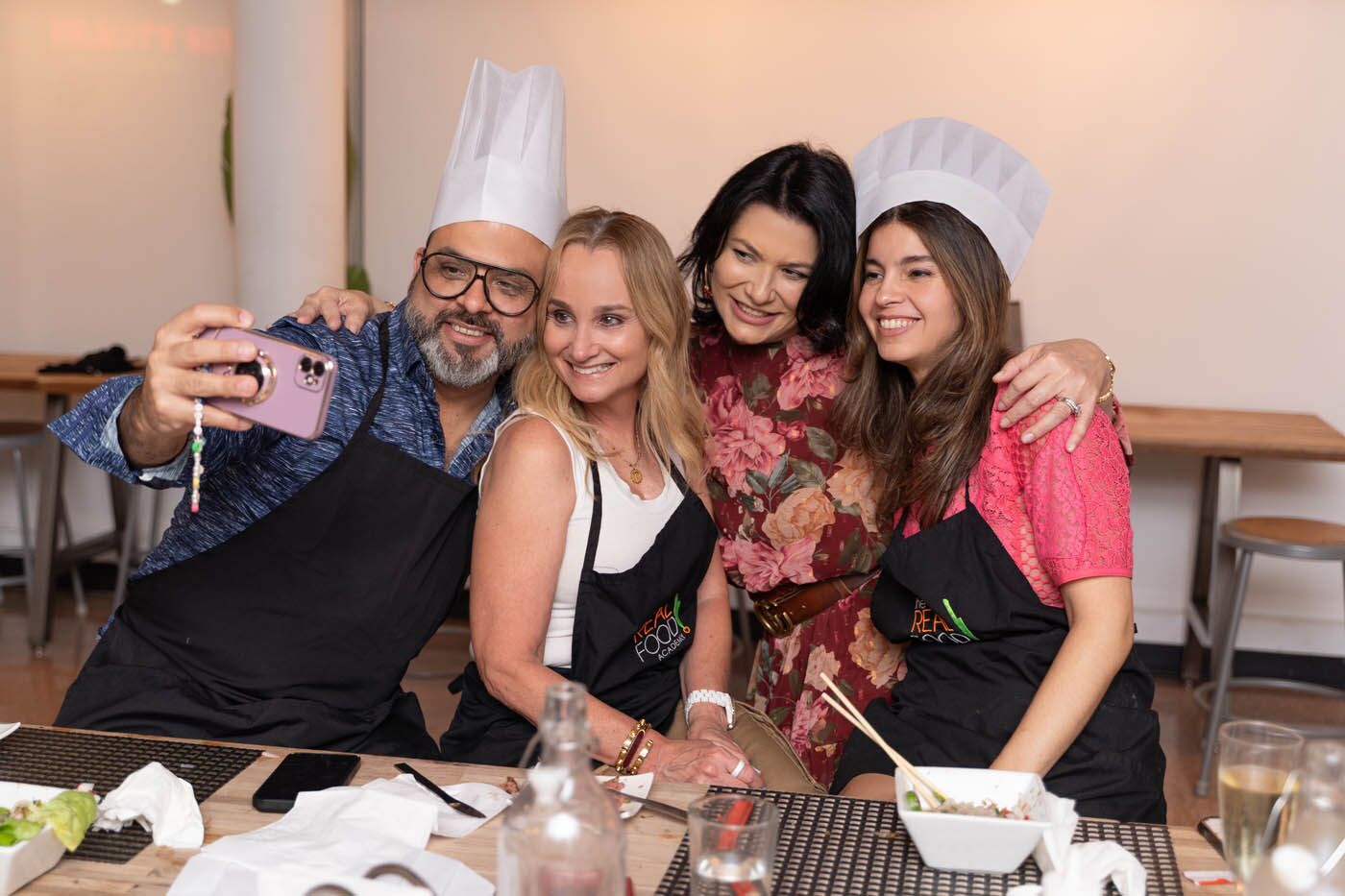 A group of friends taking a picture at The Real Food Academy adult birthday party venues. 