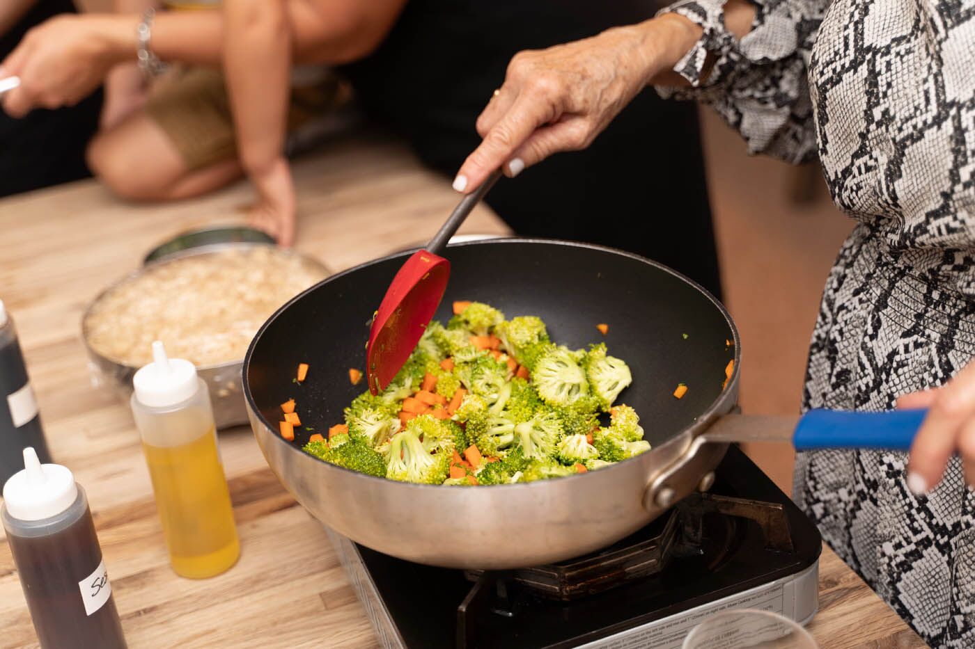 A corporate team memeber making fresh vegatibles at The Real Food Academy's corporate experience.