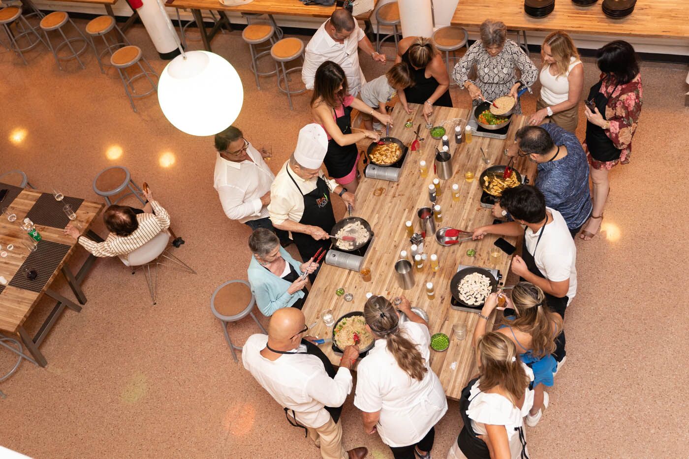 A family at a The Real Food Academy cooking table, book now with our birthday celebration place.