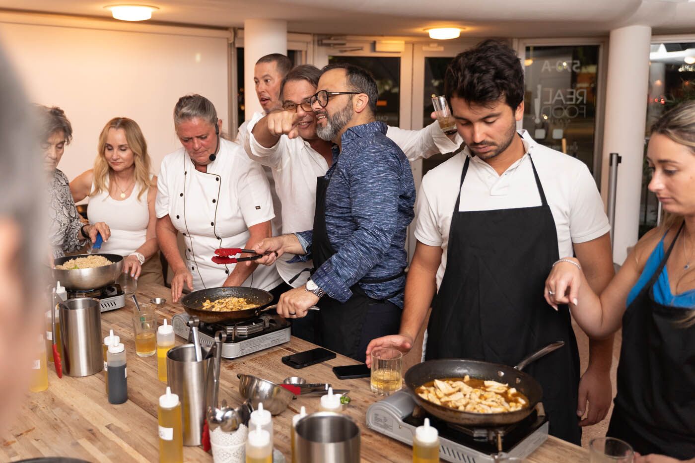 A group of team members drinking and laughing at The Real Food Academy's corporate party venue. 