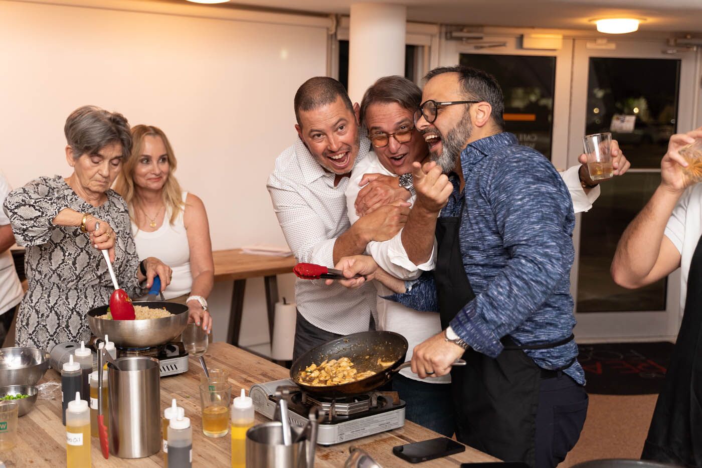 A group of men laughing during their team building activity at The Real Food Academy.