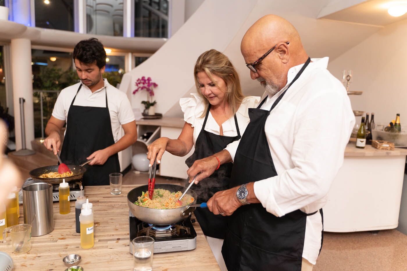 A couple making fried rice together at {fran_brand_names} couples cooking class.