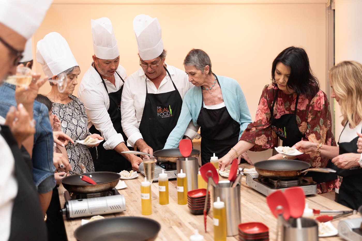 A group of team members cooking their meal led by our The Real Food Academy chef, check out our corporate party venues.
