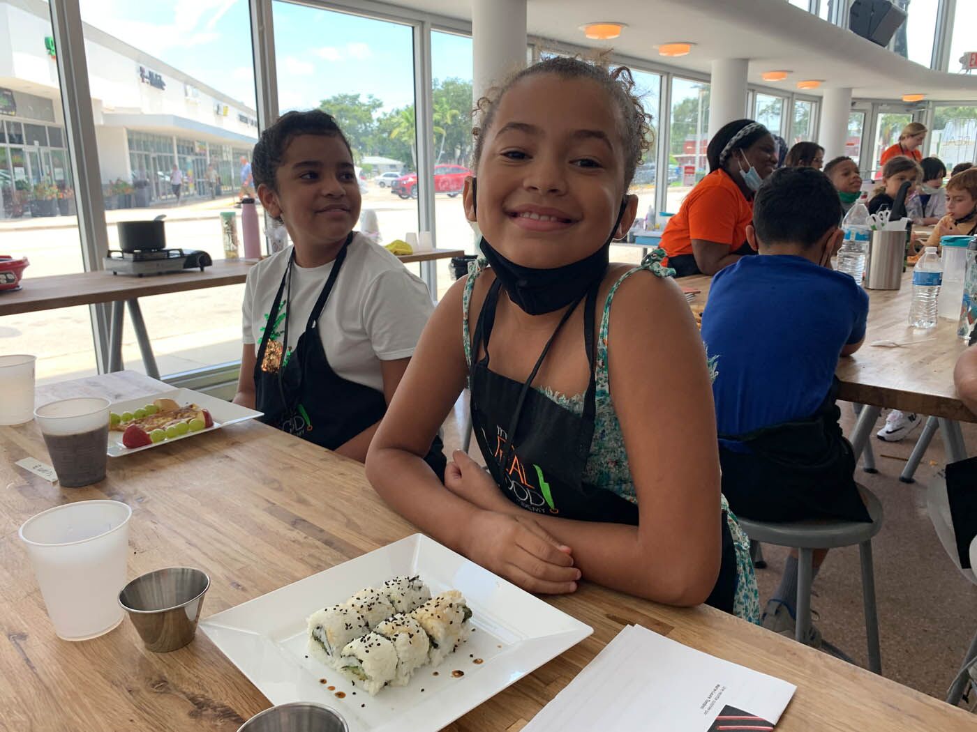 A little girl with a fresh made meal at The Real Food Academy's camps for summer.