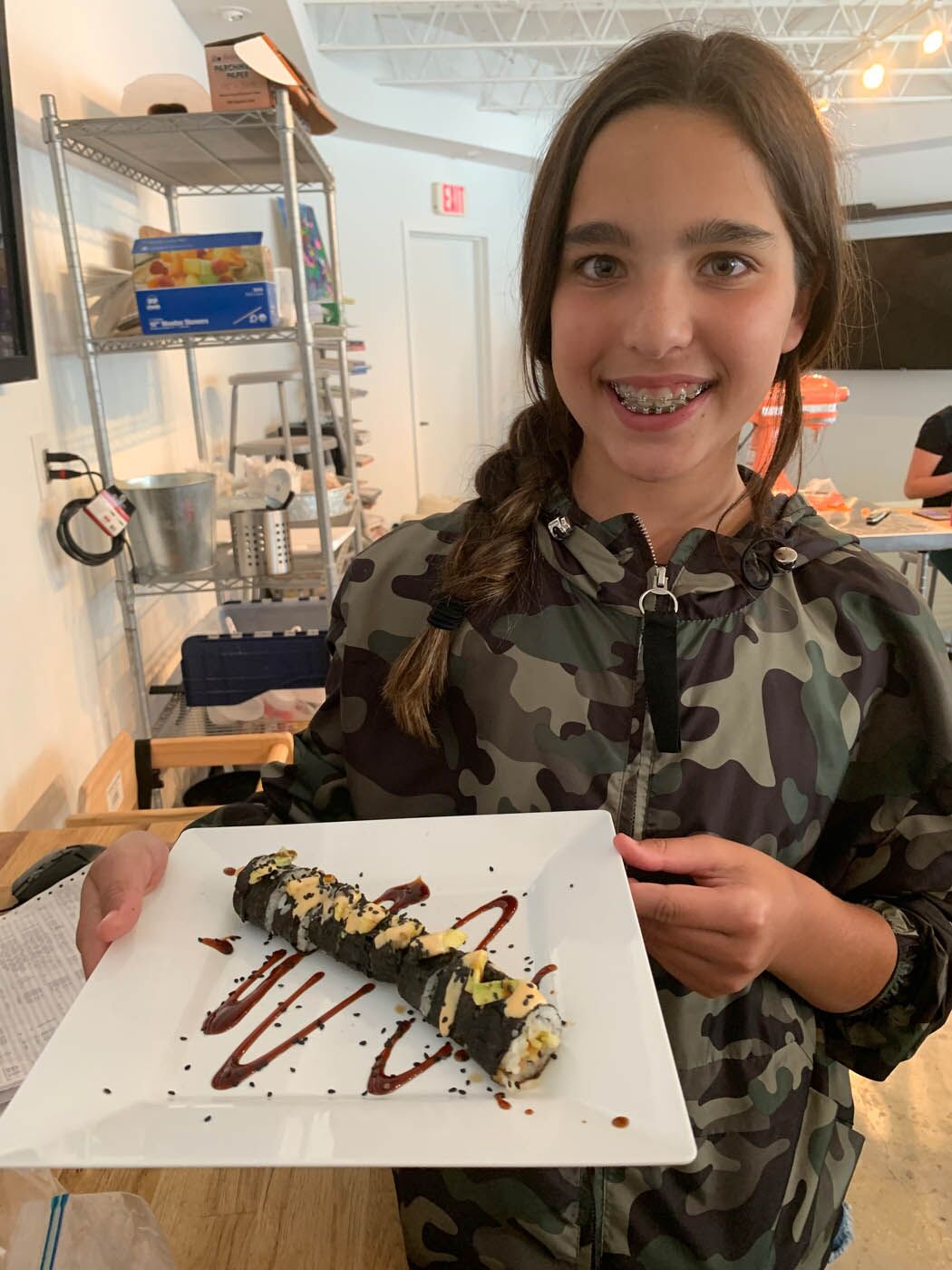 A teen with their delicious sushi creation at The Real Food Academy's teen cooking camp.