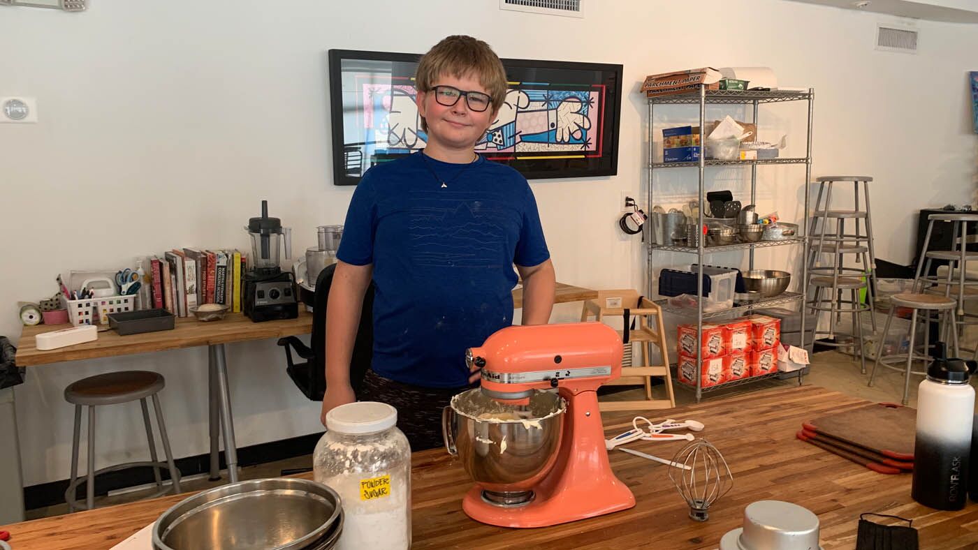 A boy mixing up magic at The Real Food Academy's kids cooking camp.