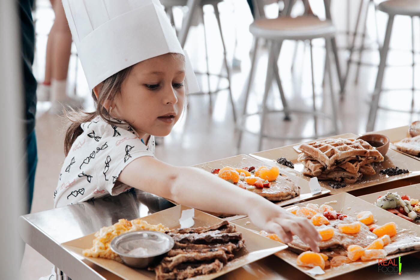 A girl at The Real Food Academy kids cooking camp.