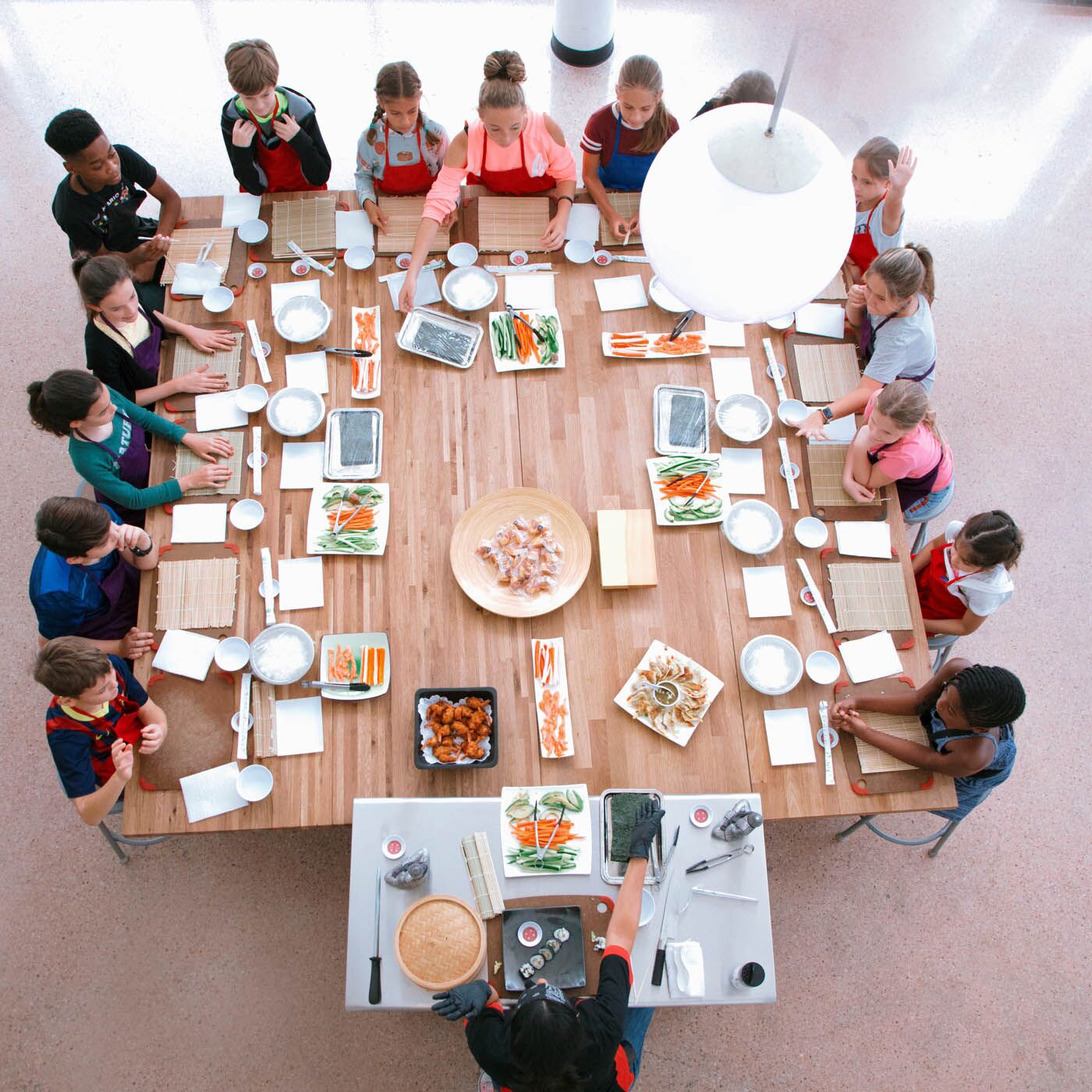 A overhead shot of {fran_brand_names} cooking table at one of our kid chef class.