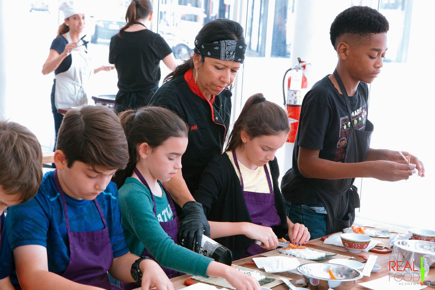 A kids cooking camp with Chef Maria who is teaching the kids.