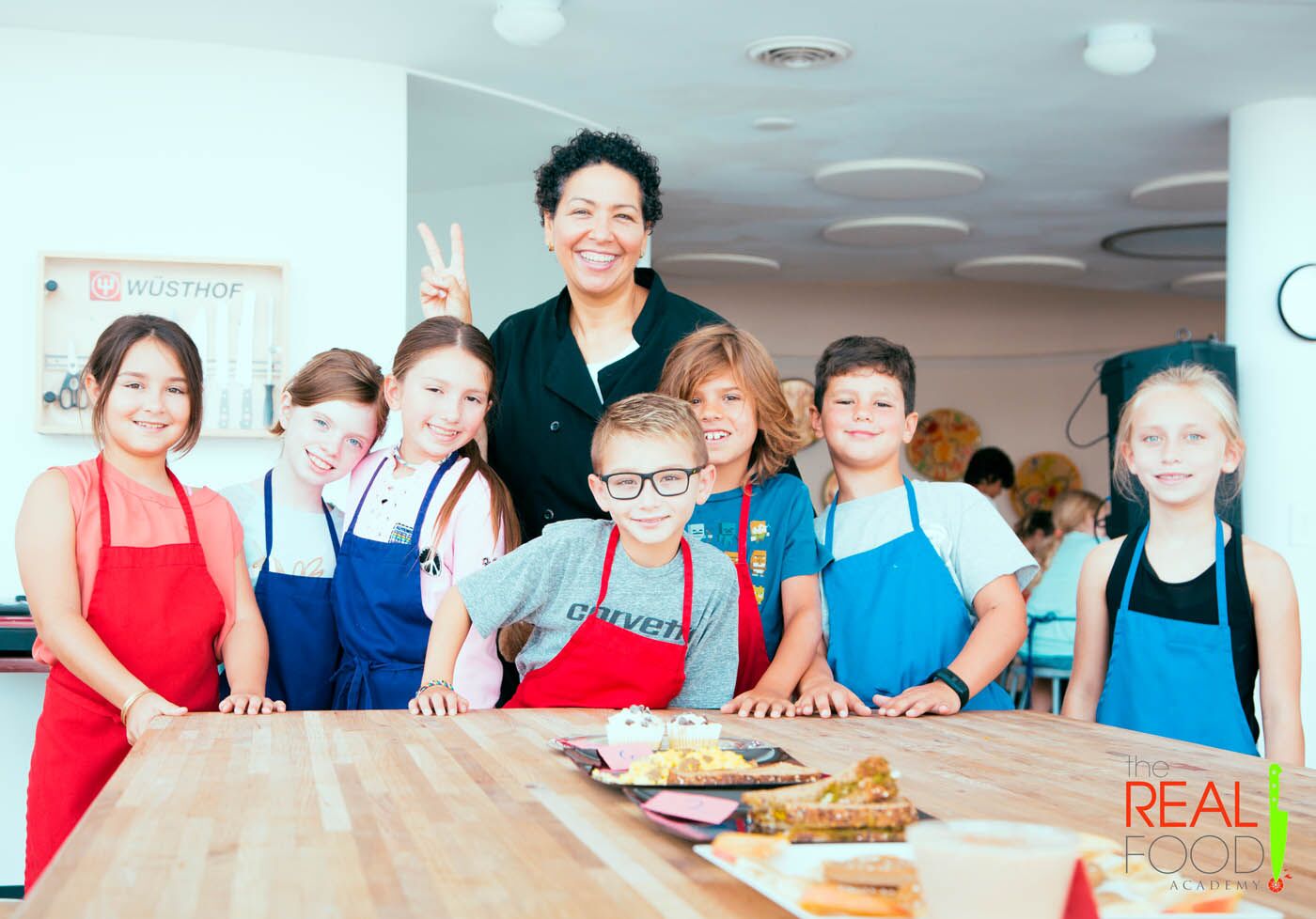 A chef with a group of kids with fresh made sandwiches at The Real Food Academy's after school program.