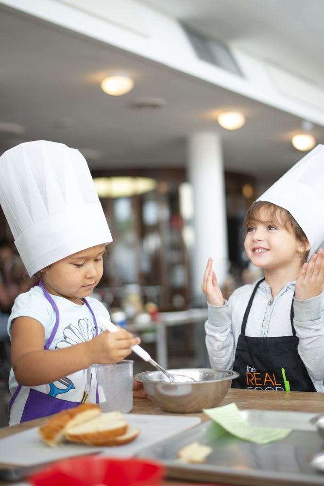 Two young children cooking together at The Real Food Academy.