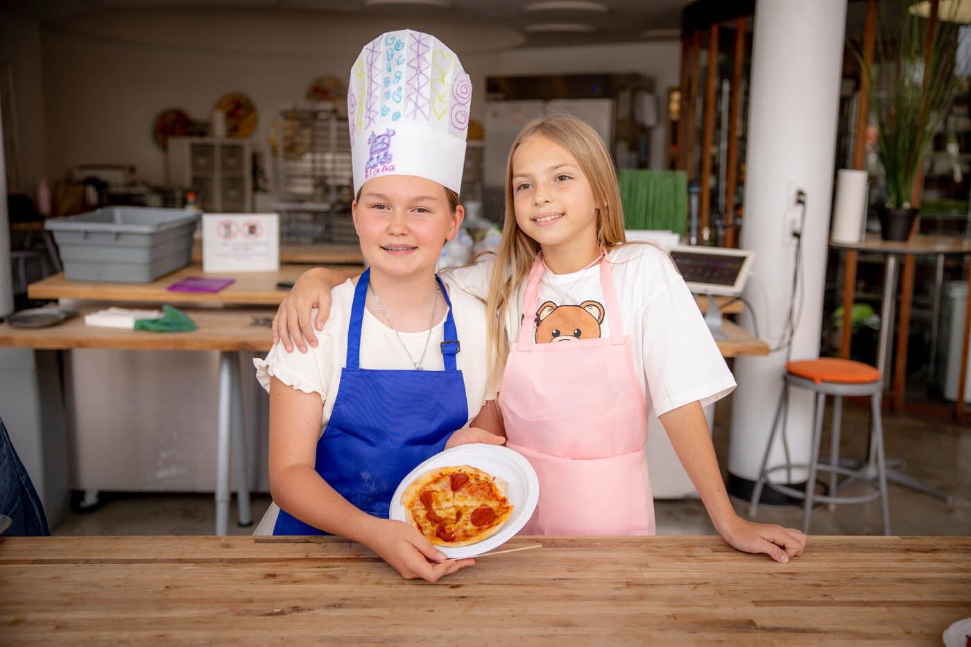 Two young girls having fun at a kids-only Valentine's class at The Real Food Academy.