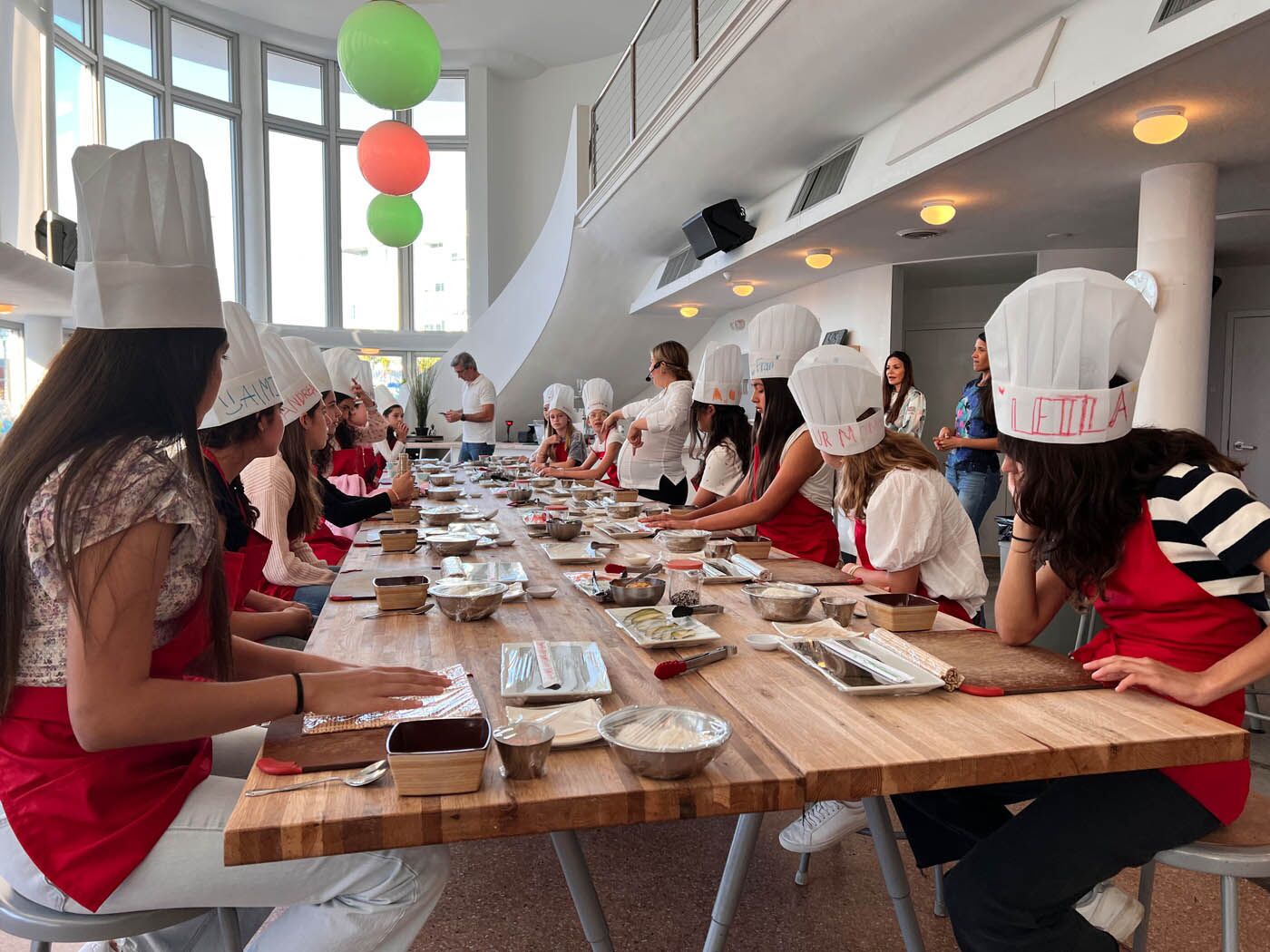 A little girl with a The Real Food Academy apron, a birthday party venue.