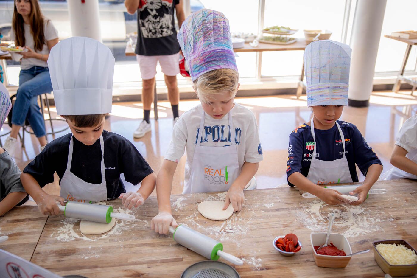 Two young kids making fresh food at The Real Food Academy - one of the best kids birthday party places. 