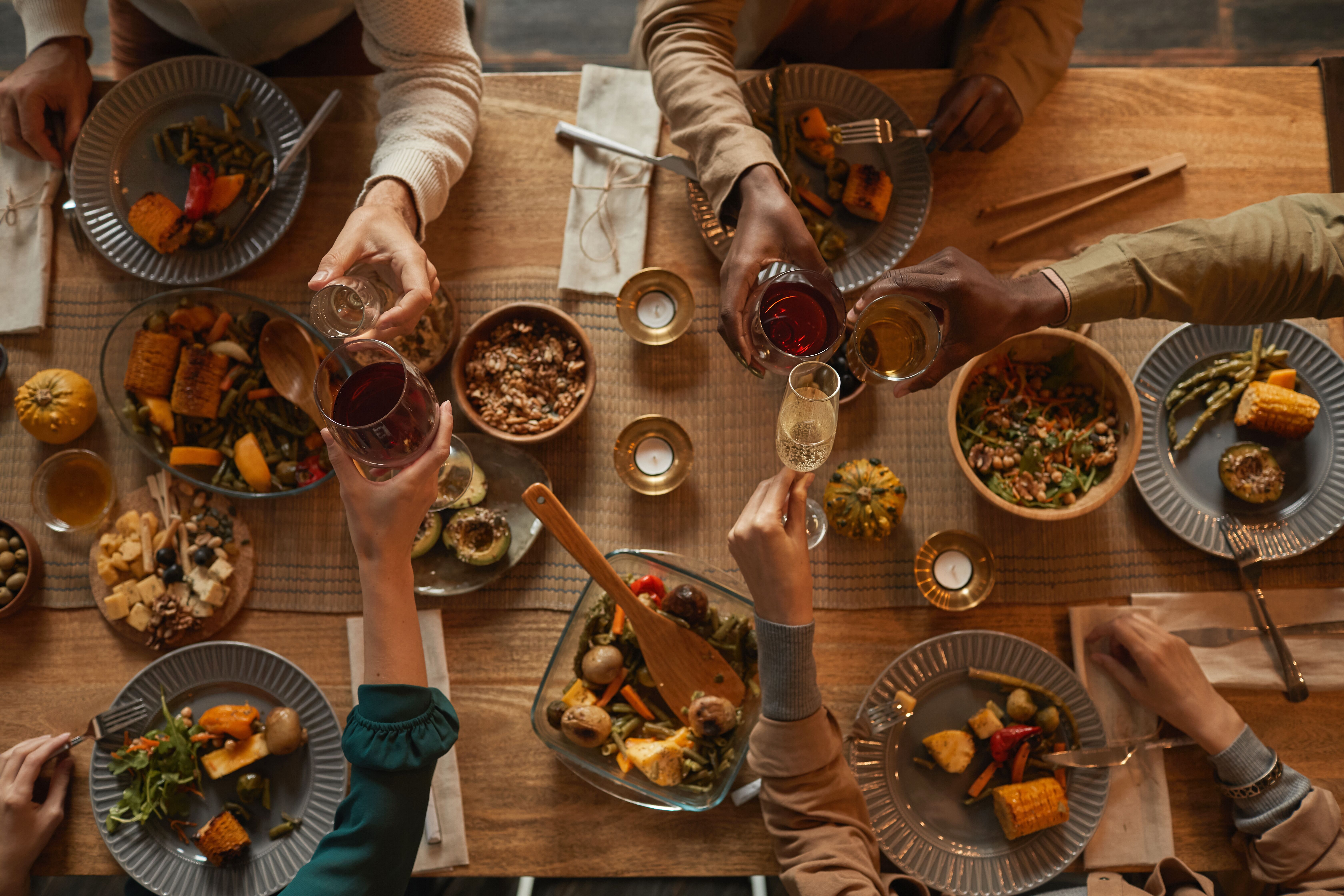 A table filled with healthy, delicious food at a dinner party - learn how to cook for a dinner party with The Real Food Academy!