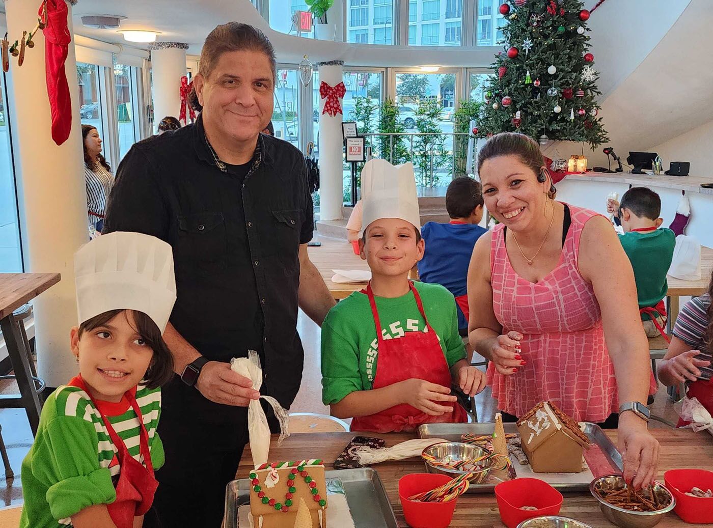 Adults and kids enjoying our gingerbread house cooking classes.