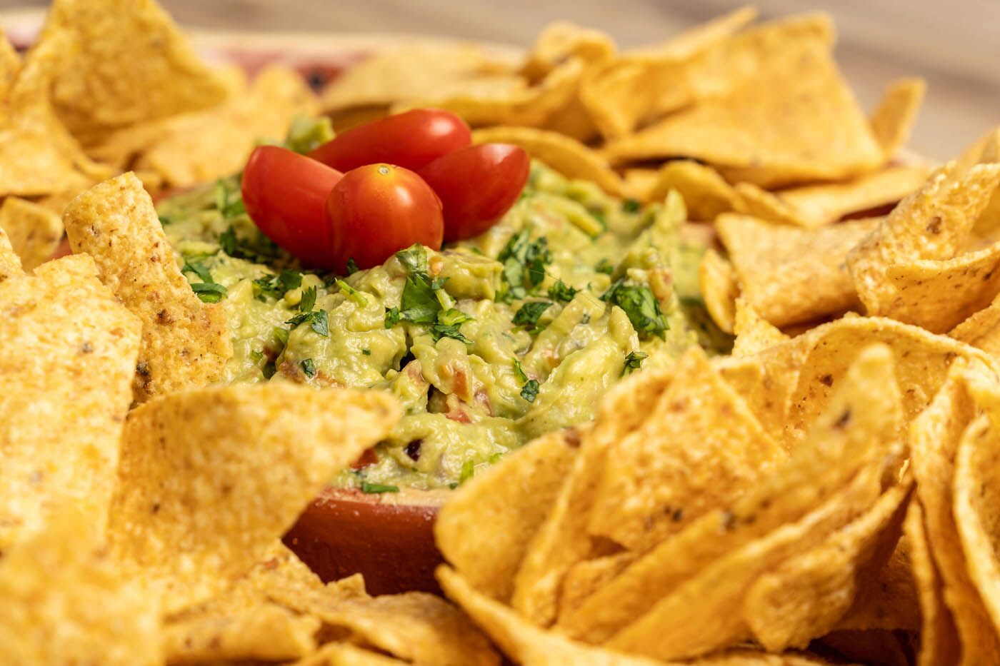 Guacamole dip with tortilla chips at The Real Food Academy.