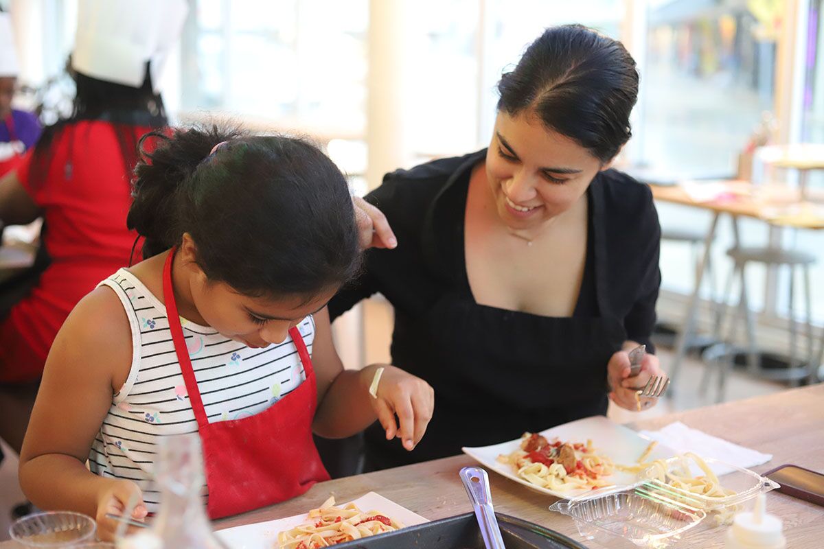 A mom and daughter cooking pasta at The Real Food Academy.