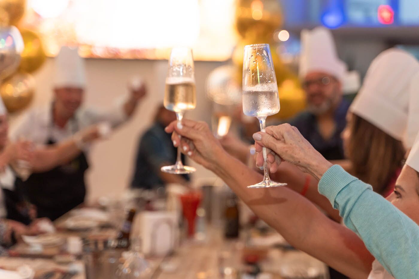 Two champaign glasses being drank at The Real Food Academy cooking classes.
